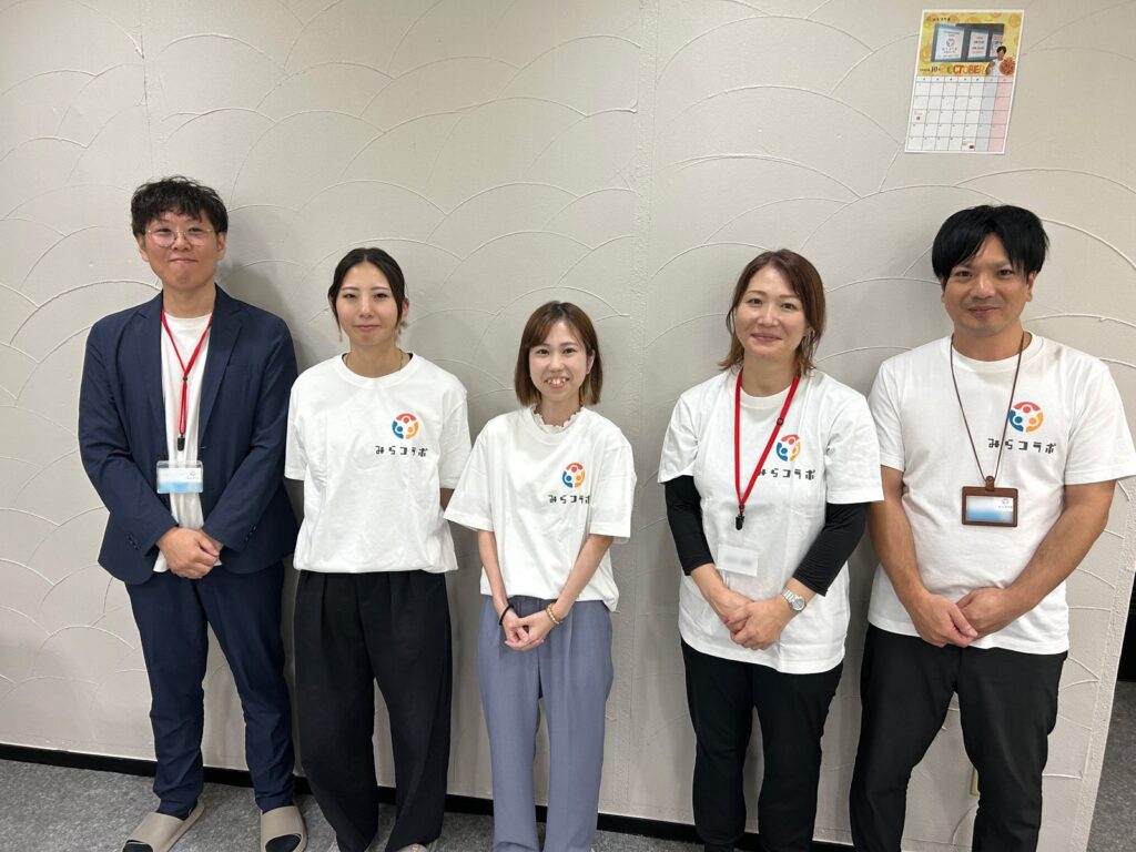 みらコラボのスタッフが笑顔で並んでいる集合写真
